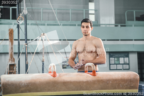 Image of The sportsman before difficult exercise, sports gymnastics