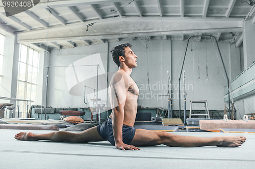 Image of caucasian man gymnastic acrobatics equilibrium posture at gym background