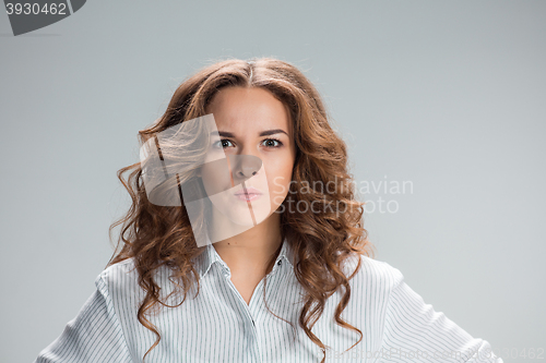 Image of The happy thoughtful woman on gray background