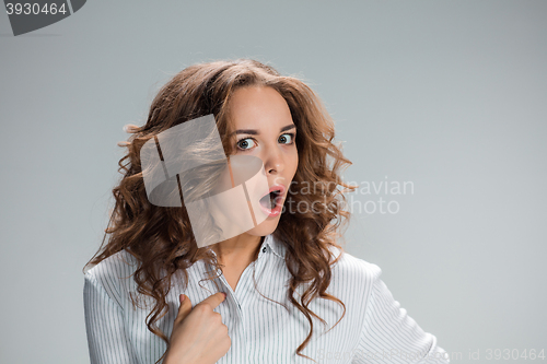 Image of Portrait of young woman with shocked facial expression