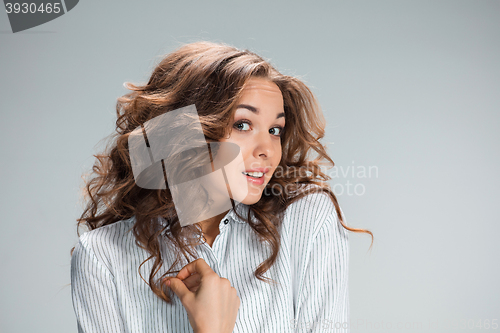 Image of The astonished woman on gray background