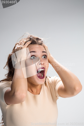 Image of Portrait of young woman with shocked facial expression