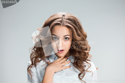 Image of The astonished woman on gray background