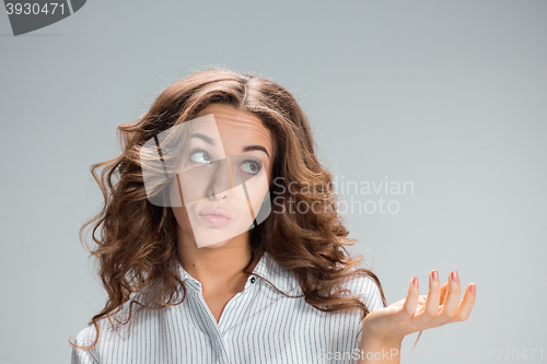 Image of The happy thoughtful woman on gray background