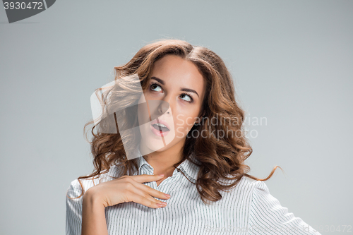 Image of The happy thoughtful woman on gray background