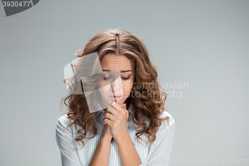 Image of Woman is looking imploring over gray background