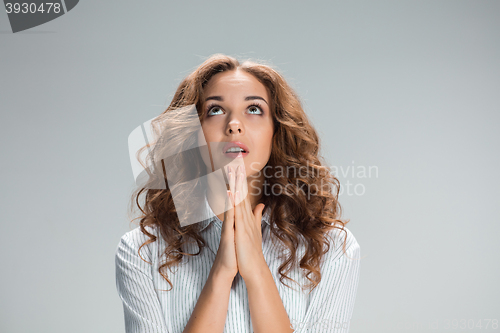 Image of Woman is looking imploring over gray background