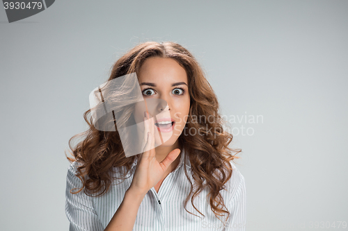 Image of Portrait of young woman with shocked facial expression