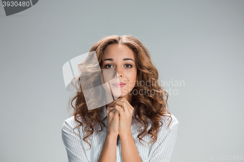 Image of Woman is looking imploring over gray background