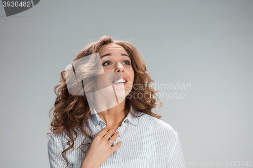 Image of Woman is looking imploring over gray background