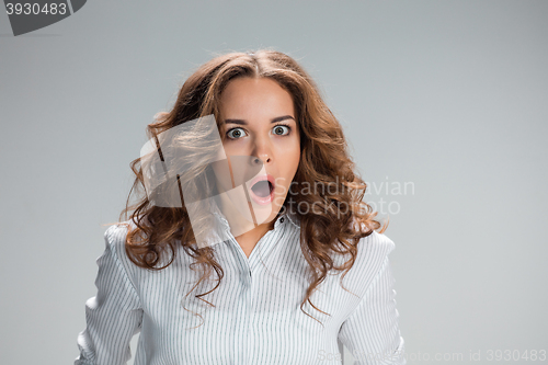 Image of Portrait of young woman with shocked facial expression