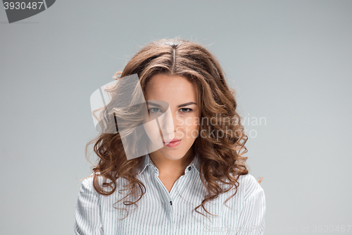 Image of The happy thoughtful woman on gray background