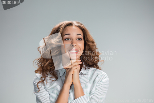 Image of Woman is looking imploring over gray background