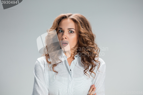 Image of Portrait of young woman with shocked facial expression