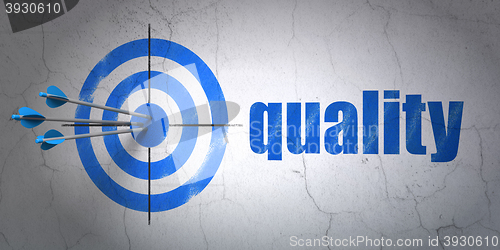 Image of Advertising concept: target and Quality on wall background
