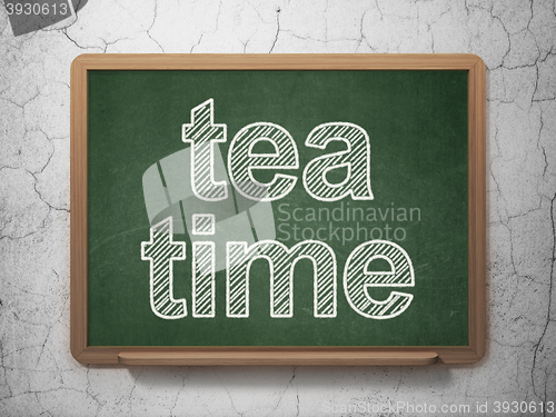 Image of Time concept: Tea Time on chalkboard background