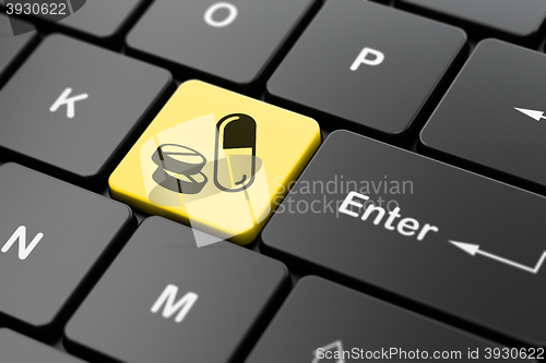 Image of Medicine concept: Pills on computer keyboard background