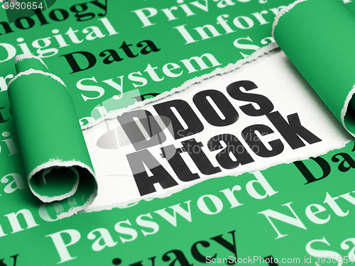 Image of Privacy concept: black text DDOS Attack under the piece of  torn paper