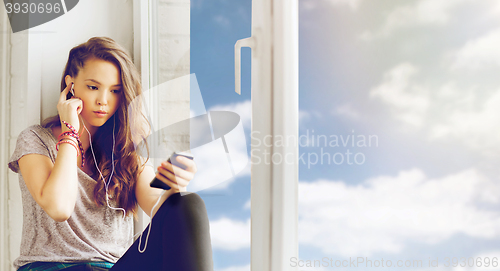 Image of teenage girl with smartphone and earphones