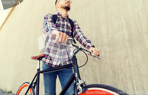 Image of hipster man with fixed gear bike and backpack