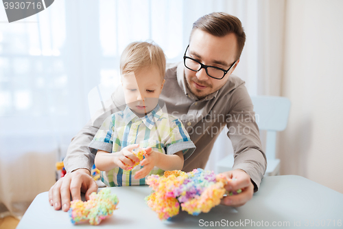 Image of father and son playing with ball clay at home