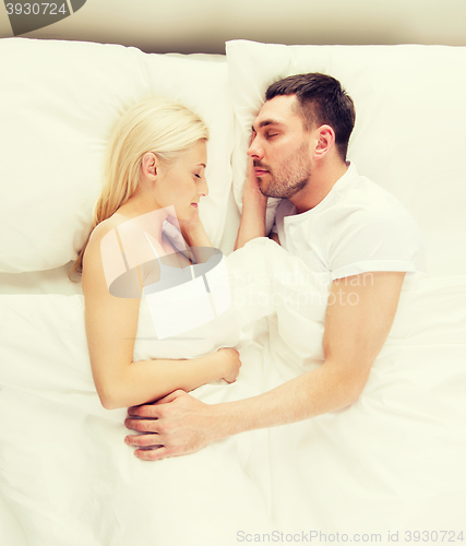 Image of happy couple sleeping in bed at home