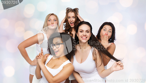 Image of group of happy women in white underwear having fun