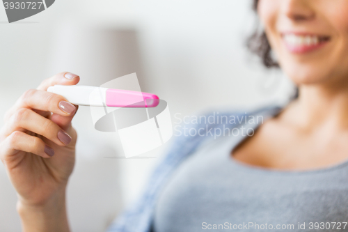 Image of close up of happy woman with home pregnancy test