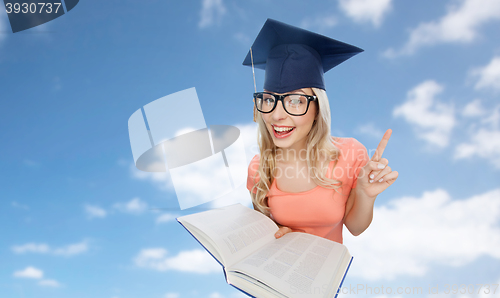 Image of student woman in mortarboard with encyclopedia