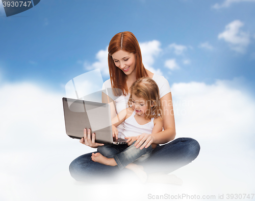 Image of happy mother with adorable little girl and laptop