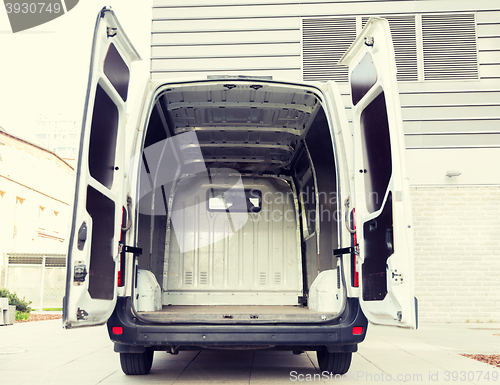 Image of empty minivan car with open doors on city parking