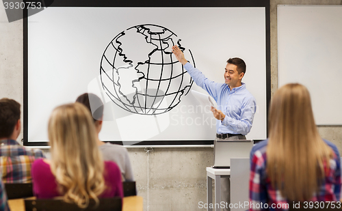 Image of group of students and happy teacher at white board