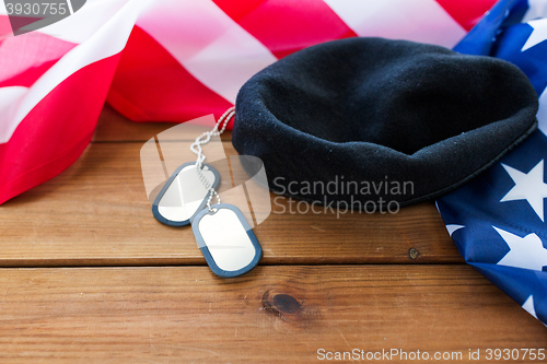 Image of close up of american flag, hat and military badge