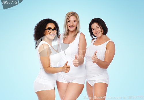 Image of group of happy plus size women showing thumbs up