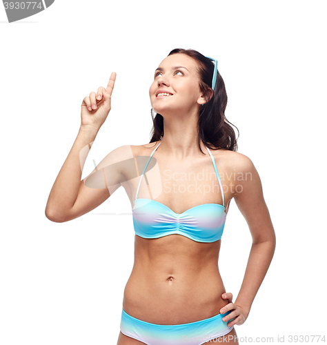 Image of happy woman in bikini swimsuit pointing finger up