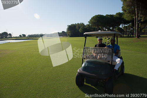 Image of golf players driving cart at course