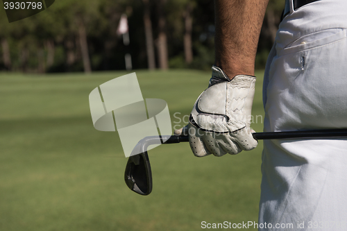 Image of golf player close up hand and driver from back