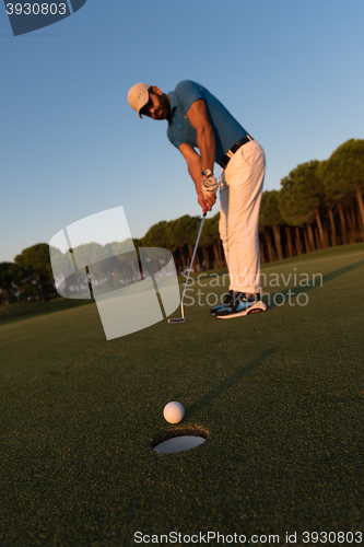 Image of golfer  hitting shot at golf course