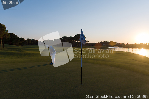 Image of golfer hitting ball to hole