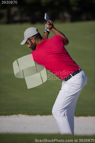 Image of golfer hitting a sand bunker shot