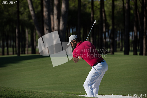 Image of golfer hitting a sand bunker shot