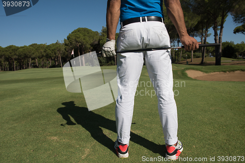 Image of golf player close up hand and driver from back