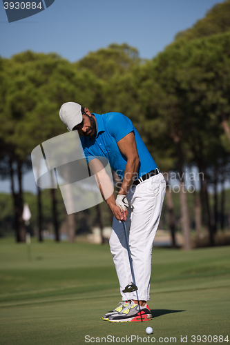 Image of golf player hitting shot at sunny day