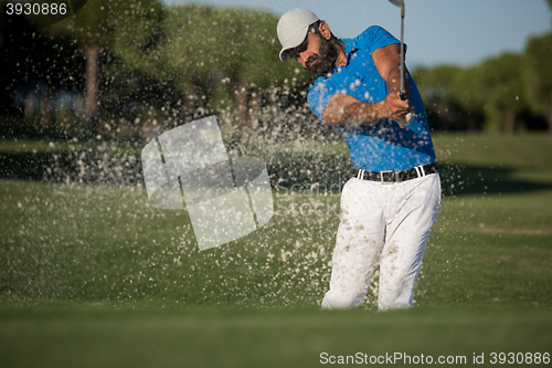 Image of pro golfer hitting a sand bunker shot