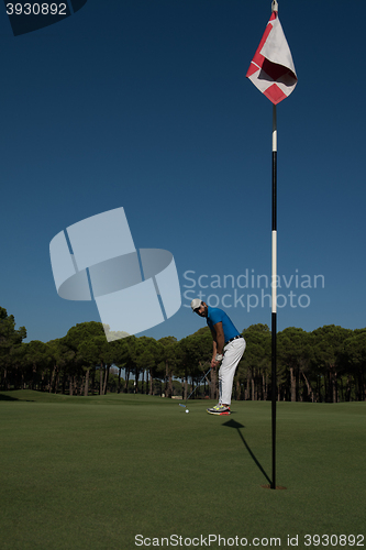 Image of golf player hitting shot at sunny day