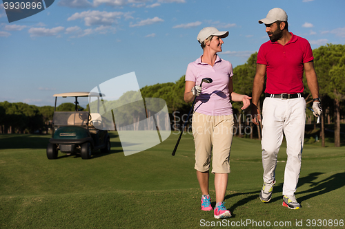 Image of couple walking on golf course