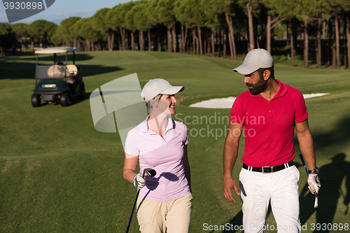 Image of couple walking on golf course