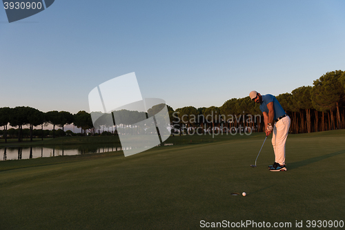 Image of golfer  hitting shot at golf course