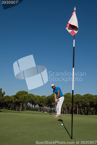 Image of golf player hitting shot at sunny day