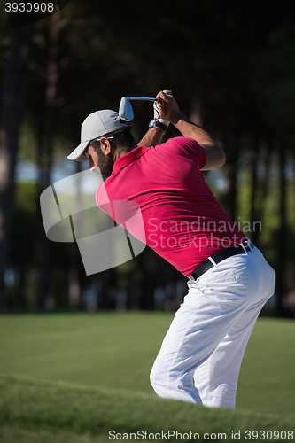 Image of golfer hitting a sand bunker shot